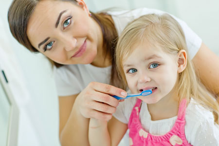 Mom and Daughter brushing their teeth - Pediatric Dentist in Portage, MI
