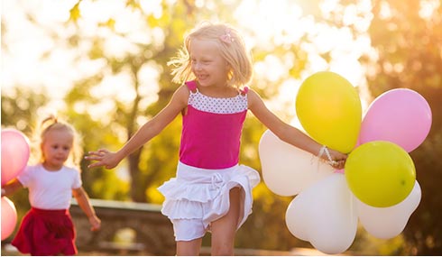 Girl with balloons - Pediatric Dentist in Portage, MI